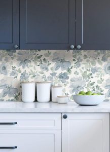 A stylish combination of dull blue slate cabinets paired with patterned wallpaper, creating a sophisticated and modern look. The muted blue tones offer a calm and refined vibe, perfectly complemented by the intricate wallpaper design.