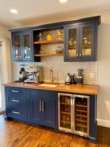 Glossy cobalt blue cabinets in a butler's pantry, adding a vibrant pop of color and a touch of sophistication to the space. The shiny finish enhances the pantry's elegance.