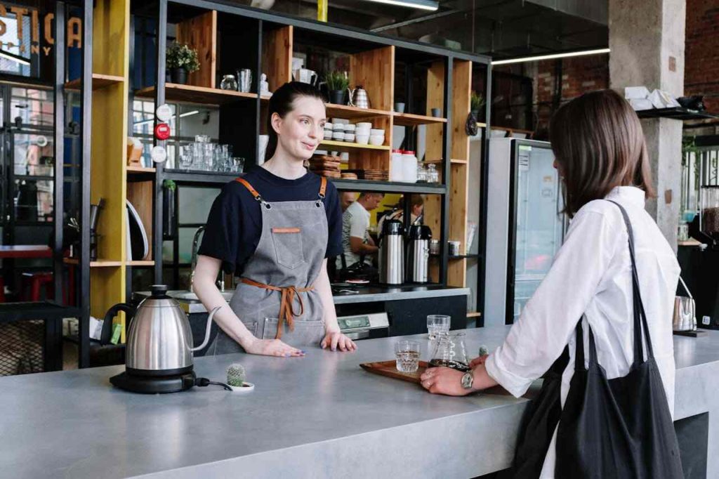 A bustling café with customers enjoying their drinks, representing strategies to boost sales in a café business.