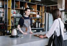 A bustling café with customers enjoying their drinks, representing strategies to boost sales in a café business.