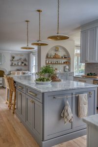 Light blue cabinets in an open kitchen layout, creating a fresh and airy ambiance. The soft blue tones complement the open space, adding a calming and modern touch.