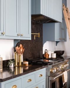 Light blue kitchen cabinets paired with sophisticated granite countertops, creating a fresh and elegant design. The soft blue tones and sleek granite offer a perfect blend of style and luxury.