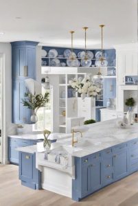 A cheerful kitchen featuring powder blue cabinets that create a warm and inviting atmosphere. The soft hue is complemented by white countertops and rustic wooden accents, enhancing the joyful ambiance.