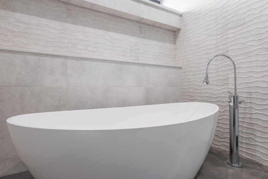 Tranquil Zen-inspired bathroom with natural elements, soft lighting, and minimalistic decor.