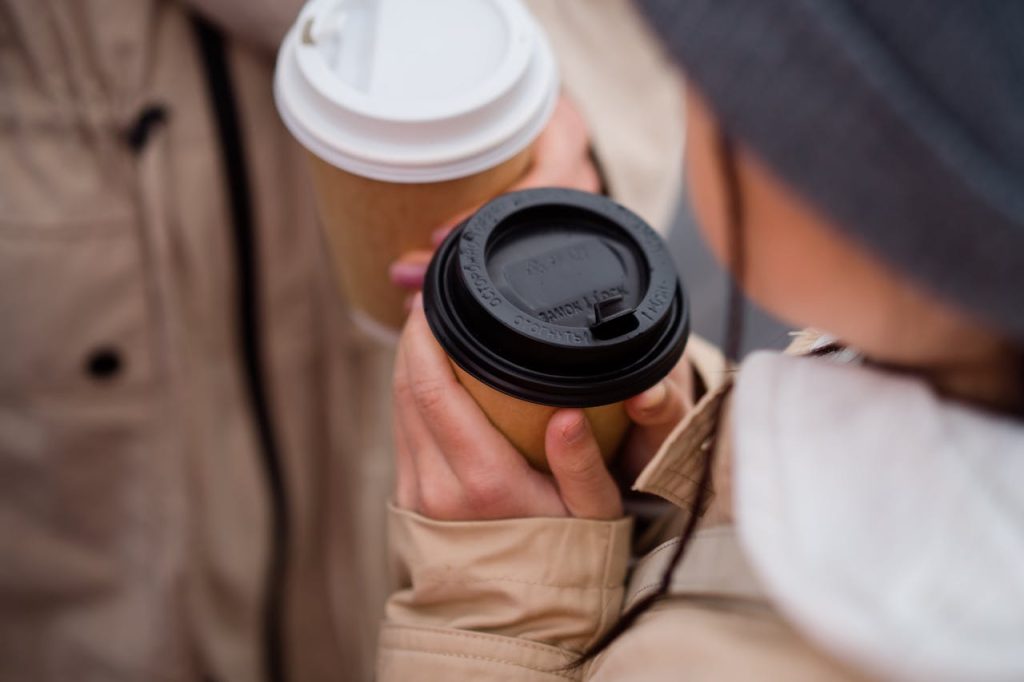 Close-up of coffee cup lids in various styles and materials, highlighting options for improved customer experience and brand appeal.